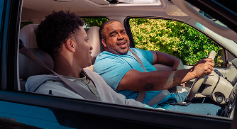 Parent talking to teen in a car.