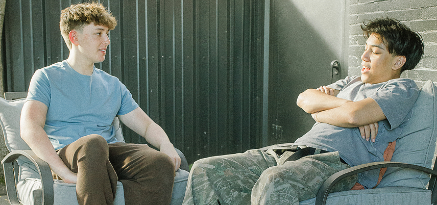 Two friends speak outside