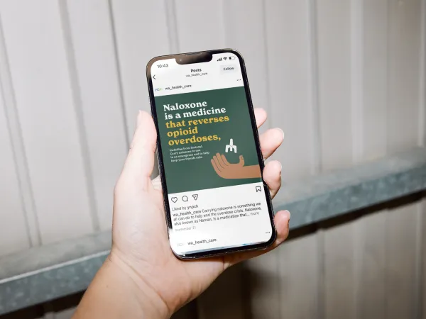 Image of a person's hand holding a phone