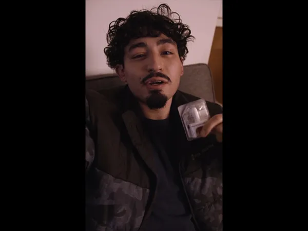 A person holding up naloxone nasal spray.